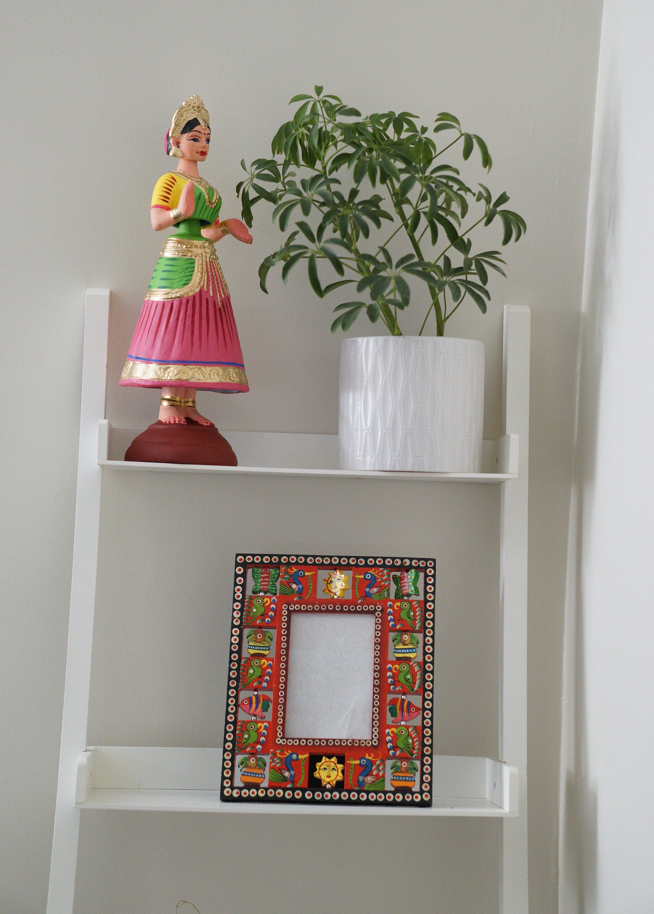 Colorful wooden photo frame with painted rotatable birds and figurines